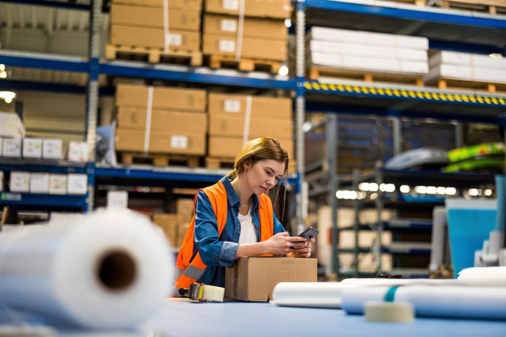 Warehouse worker scanning package using mobile phone