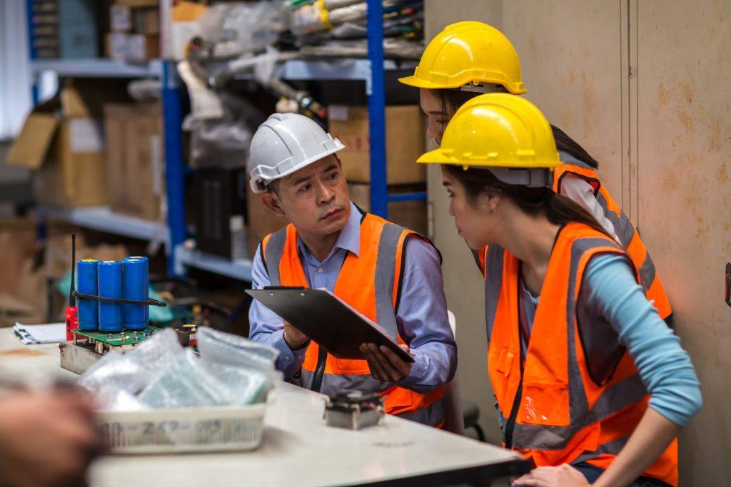 Team workers in a warehouse engaged in checking order and supply details