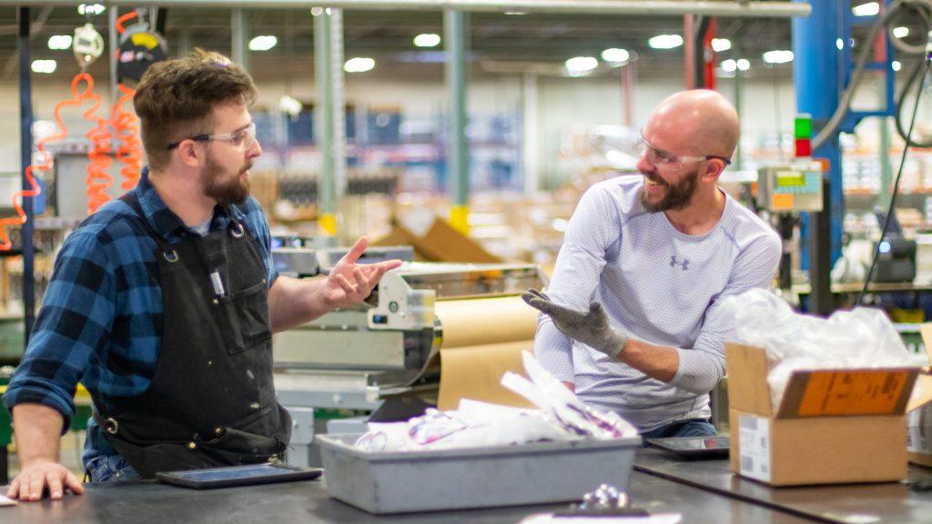 NewStream employees laughing in the warehouse